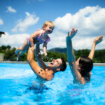 family enjoying a swim after a pool heater repair and pool maintenance was completed