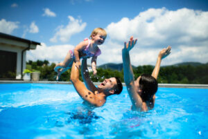 family enjoying a swim after a pool heater repair and pool maintenance was completed